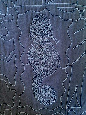 The quilting on the back of a T-shirt quilt.  this is the same seahorse that is on the front of the quilt.