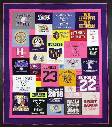 Graduation T-shirt quilt with purple and pink binding.T-shirt quilt with a border by Too Cool T-shirt Quilts