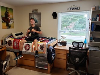 Dormroom with T-shirt quilt made by Too Cool T-shirt Quilts