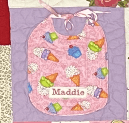 A baby bid in a quilt by Too Cool T-shirt Quilts