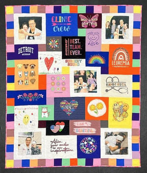 T-shirt quilt with photos and pieced border by Too Cool T-shirt Quilts