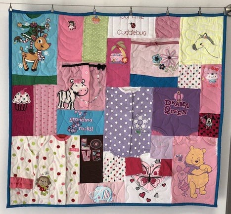 baby clothes mini quilt by Too Cool T-shirt Quilts