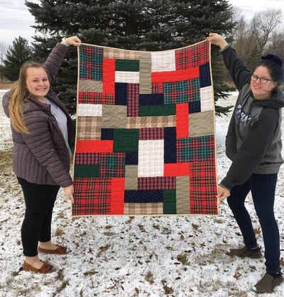 Holding up a Too Cool T-shirt Quilts in the snow