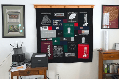 A T-shirt quilt hanging in an office Too Cool T-shirt Quilts